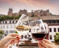 Red and white wine glass in front of Heidelberg Castle