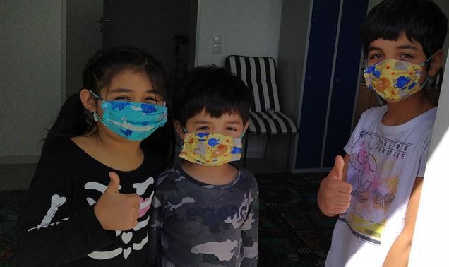 Drei Kinder mit selbst genähten Masken (Foto: Stadt Heidelberg)